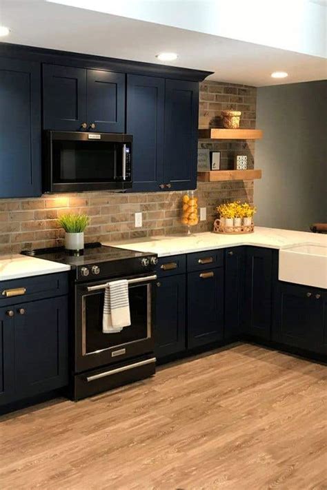 blue kitchen cabinets with stainless steel countertops|blue cabinets with brick backsplash.